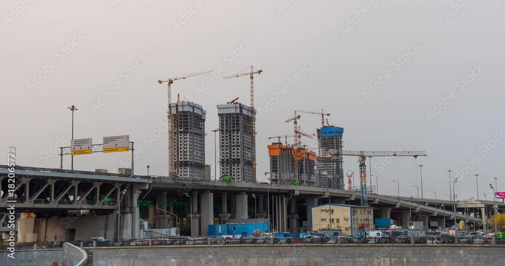 Many of cranes. Tower cranes against blue sky, with clouds. Timelapse. Many of cranes. Tower cranes against blue sky, with clouds. Timelapse.