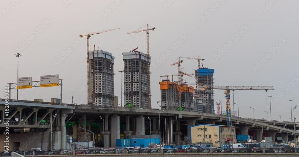 Many of cranes. Tower cranes against blue sky, with clouds. Timelapse. Many of cranes. Tower cranes against blue sky, with clouds. Timelapse.