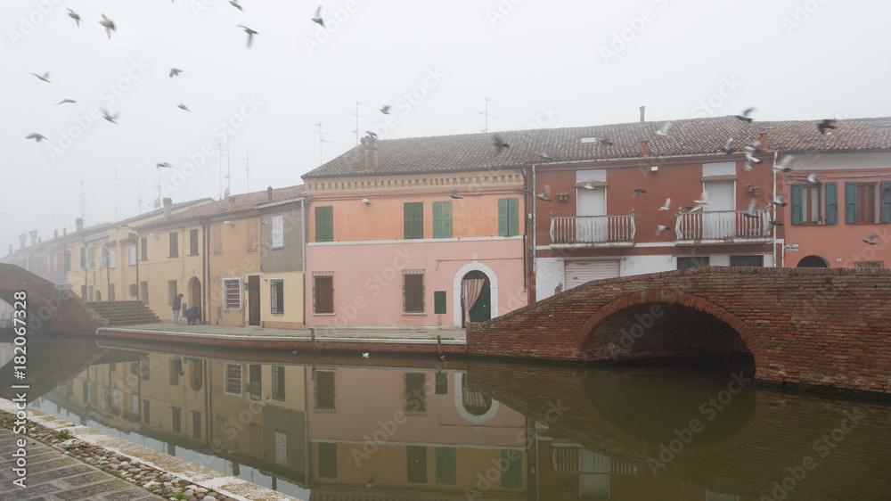 Comacchio (Italy) - Characteristic and fascinating historic town in the Park of the Po Delta, Comacchio has a maze of canals with small bridges and pastel-coloured houses.