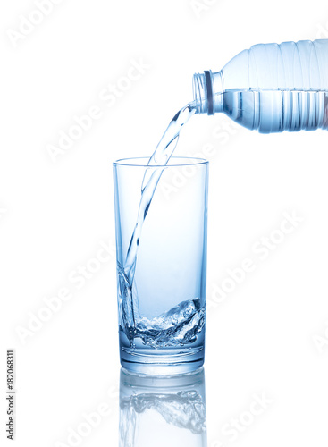 pouring water on a glass isolated on white background