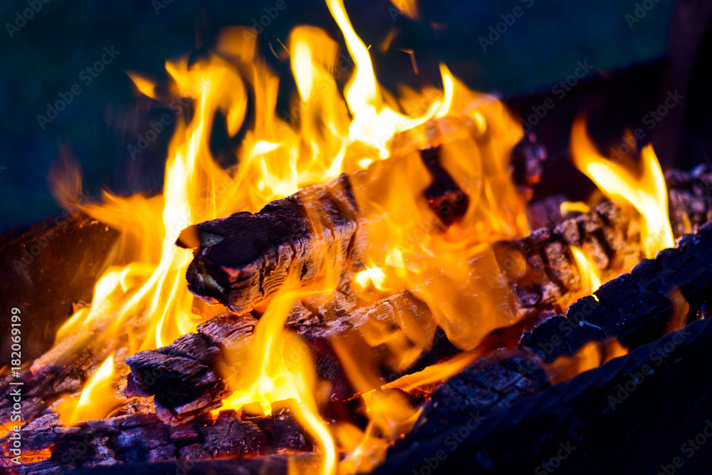 Fototapeta premium The blazing flames from the hot coals in the barbecue