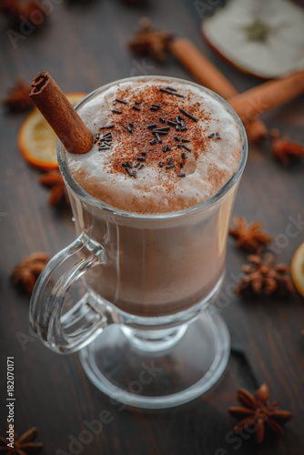 Delicious hot chocolate with cinnamon on the brown wood table