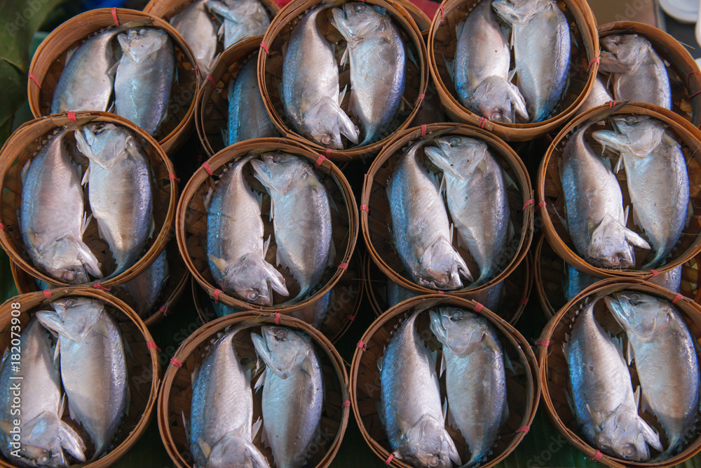 Boiled mackerel fish in round shape bamboo basket. Boiled mackerel fish in round shape bamboo basket.