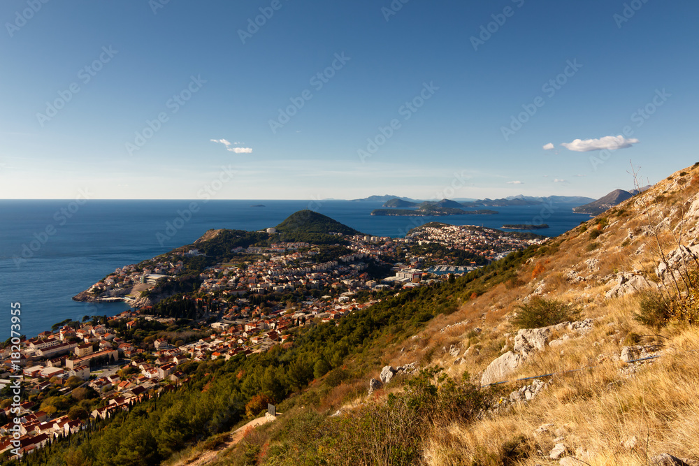 Landscape with mountains, ocean and city