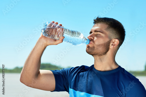 Man Drinking Water After Running. Portrait.