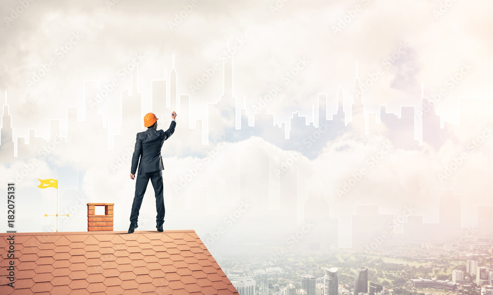 Man architect draw silhouette of modern city on blue sky. Mixed Man architect draw silhouette of modern city on blue sky. Mixed