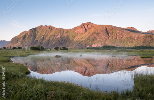Scenic mountain landscape with nice reflection at bright summer day in Lofoten Island, Norway