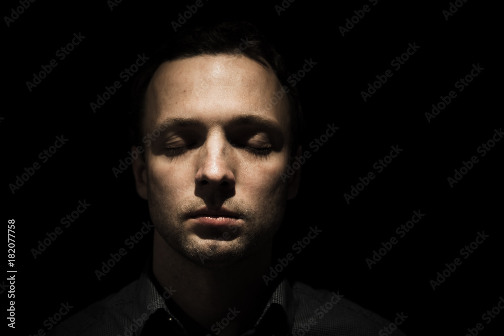 Face portrait of young man with closed eyes