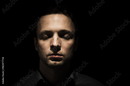 Face portrait of young man with closed eyes