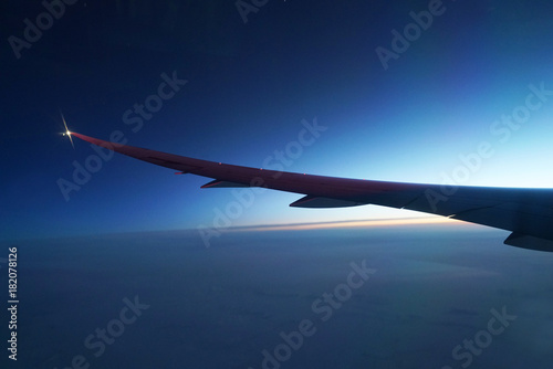 Airplane wing and twilight sky before sunrise