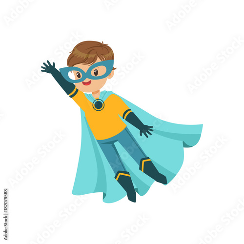 Comic brave kid in blue and yellow superhero costume, flying with one hand up. Halloween costume. Vector flat super boy character.