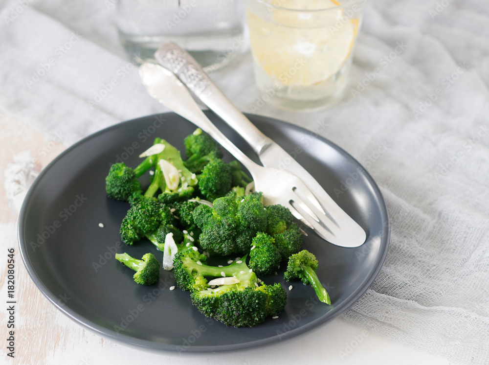 Broccoli cooked with garlic, ginger and sesame served with lemonade. Rustic style. Broccoli cooked with garlic, ginger and sesame served with lemonade. Rustic style.