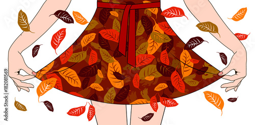 Woman's hands pull the edge of the dress with autumn fall decoration
