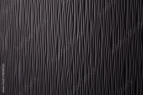 Wooden black undulating surface texture.