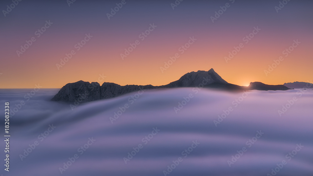 fog in the valley at misty morning with view of Anboto mountain