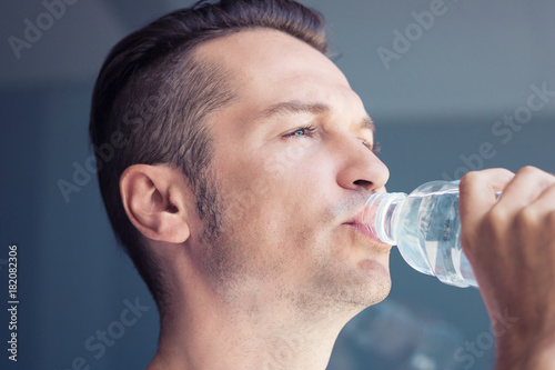 Thirsty man drinking water.