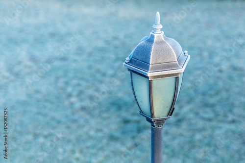 Black lantern with white hoar frost. Copy space.