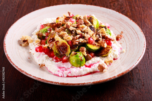 Brussels with cottage cheese, pomegranate and nut salad
