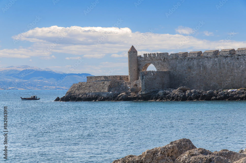 Sea in foreground and part of the castle at Greek island Rhodes