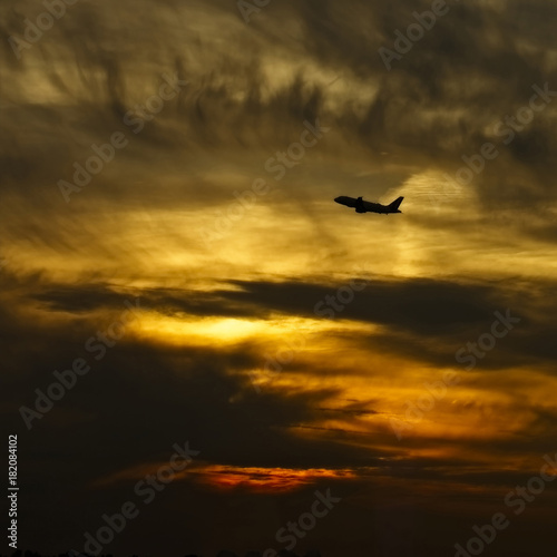 Silhouette of a jet airliner taking off at sunset  Germany.