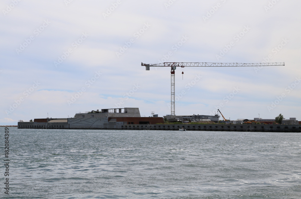 cranes and large construction site in the sea for building a dam