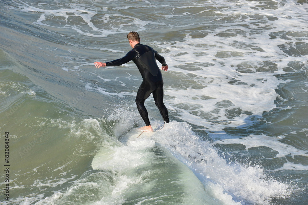 A surfer at Newport Beach, California.