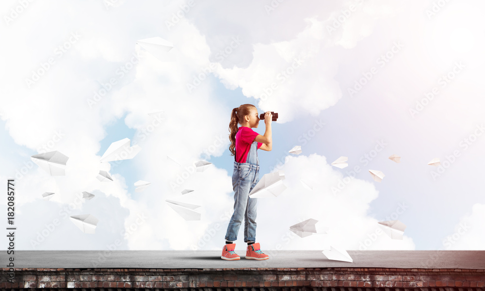 Concept of careless happy childhood with girl of school age looking in future Concept of careless happy childhood with girl of school age looking in future