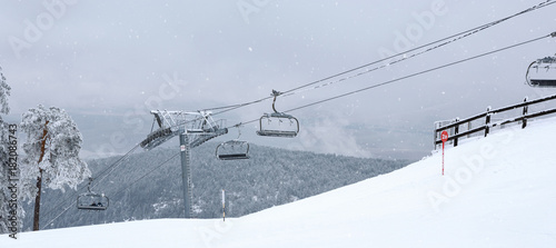 mountains with modern ski lift chair. © Lucky Fenix