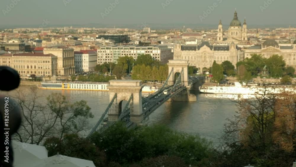 Camera slides from behind love locks to cars passing over Chain Bridge in Budapest. Shot on sunny autumn afternoon Camera slides from behind love locks to cars passing over Chain Bridge in Budapest. Shot on sunny autumn afternoon