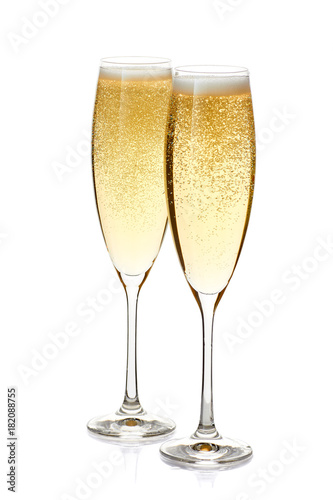 Two glasses of champagne with foam and bubbles on white