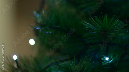 Rack Focus On A Christmas Tree Branch With Flickering Lights, Wintertime