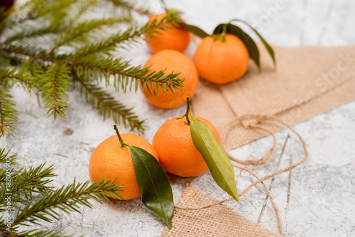 Christmas mandarins on a napkin. Textured white background photo