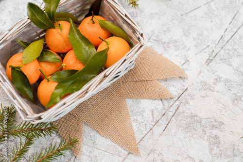Christmas mandarins on a napkin. Textured white background photo
