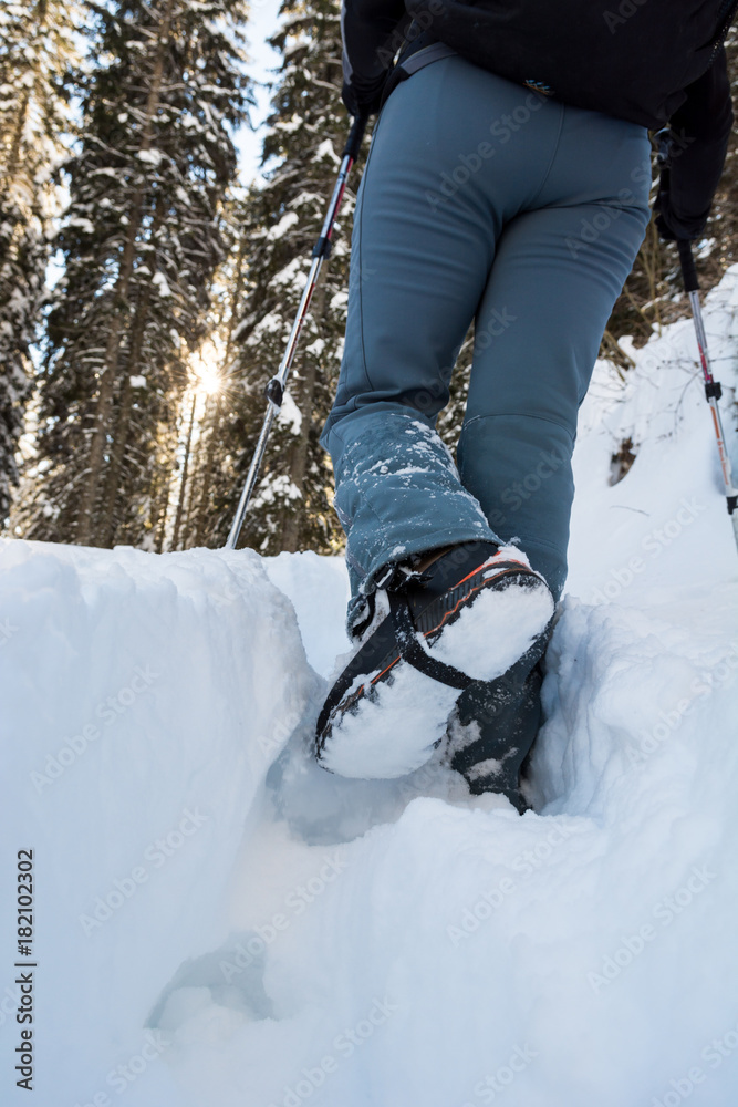 Closeup of hiking boots on a snow path. Closeup of hiking boots on a snow path.
