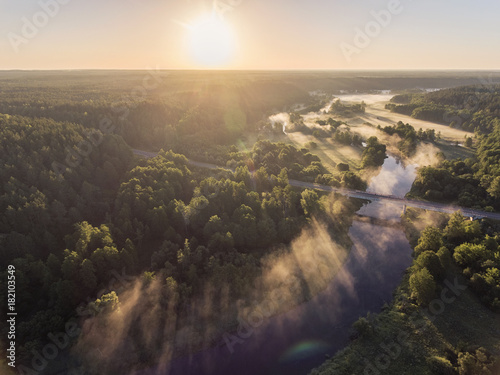 Aerial view over Merkys river valley, near Merkine town, Lithuania. During sunny summer season, surrounded by pine tree forest. © Mantas Bac