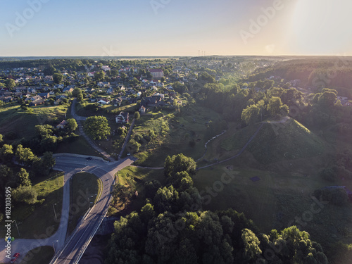 Aerial view over Merkys river valley, near Merkine town, Lithuania. During sunny summer season, surrounded by pine tree forest. photo