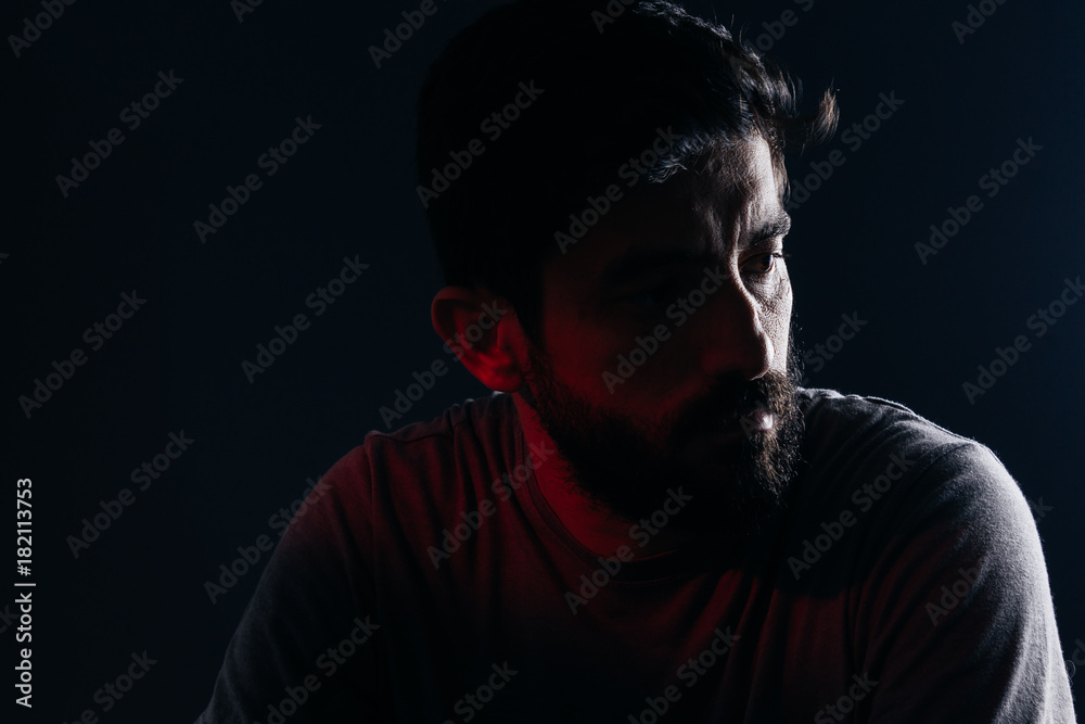 Fototapeta premium Dramatic portrait of bearded man. Concept of sadness, depression, alert