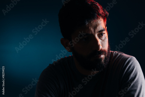 Dramatic portrait of bearded man. Concept of sadness, depression, alert