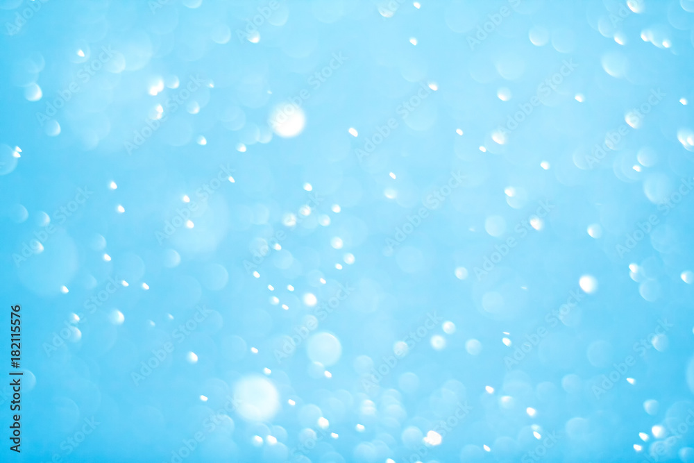 Blue lights bokeh defocus abstract background. Blue Festive Christmas. Glitter bright background.