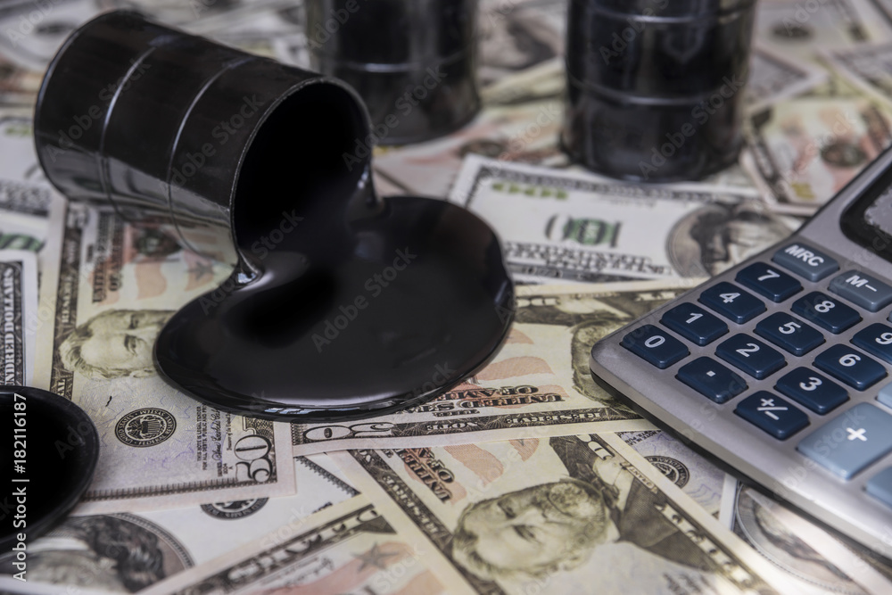 Fototapeta premium oil and barrels. poured oil on the money dollar currency. bargaining. Exchange. oil business. Profit growth rates, profit from sales of petroleum products.