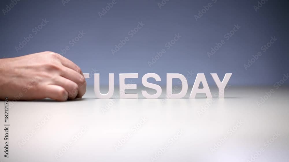 Male hand composition word tuesday on table. Second working day in weekdays Male hand composition word tuesday on table. Second working day in weekdays