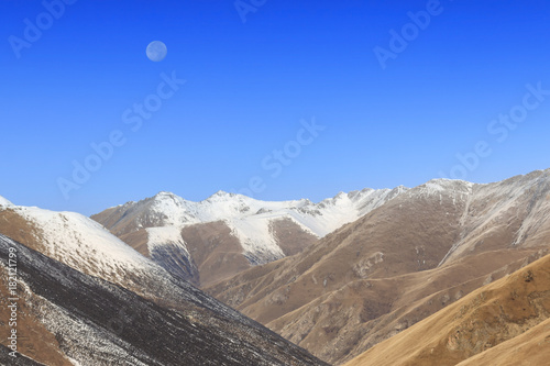 Moon rising over Mountain Tibetan Himalayan landscape in SiChuan province, China photo