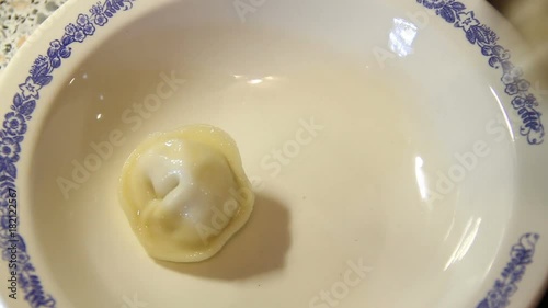 Putting some on a plate of cooked dumplings photo