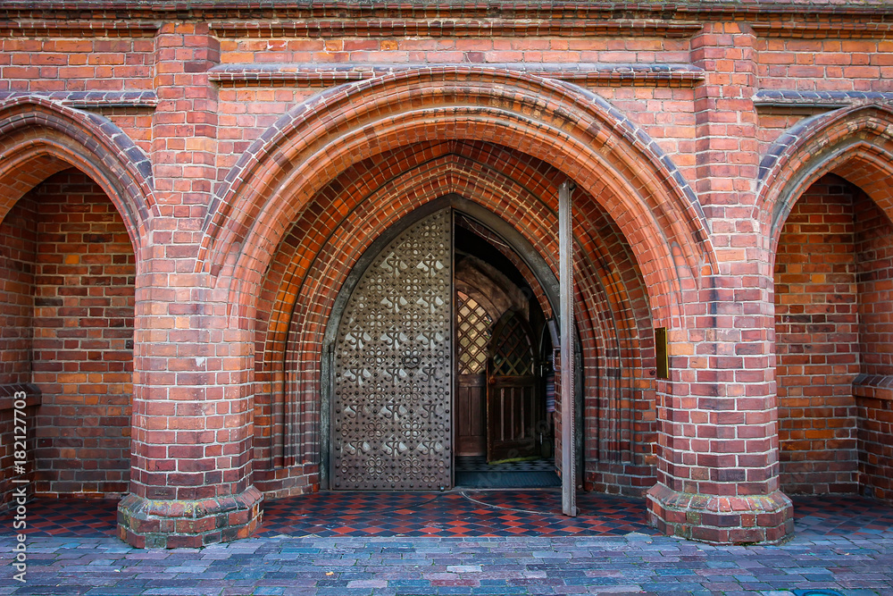 Entrance arch to Catholic Church of Gothic style of red brick. Brick arches in the Catholic cathedral st. Anne in Vilnius, Lithuania