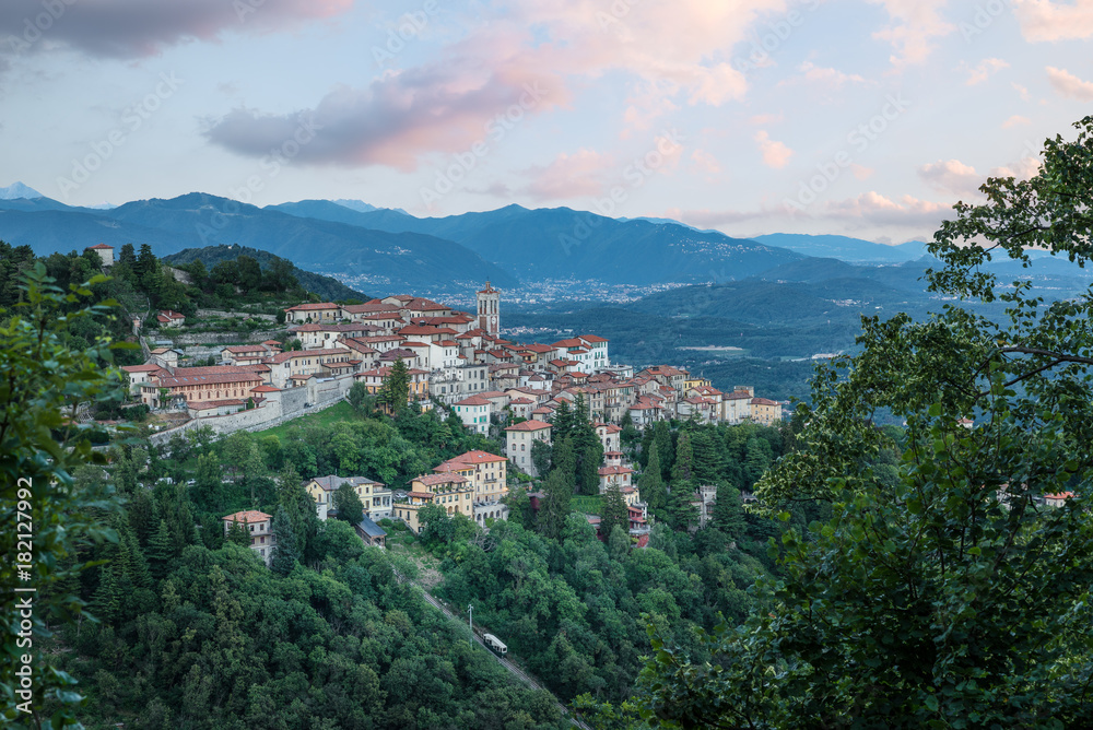 Sacro Monte of Varese (Santa Maria del Monte), Varese - Italy. Picturesque view of the small medieval village at sunset. Below the funicular is visible. World heritage site - UNESCO site