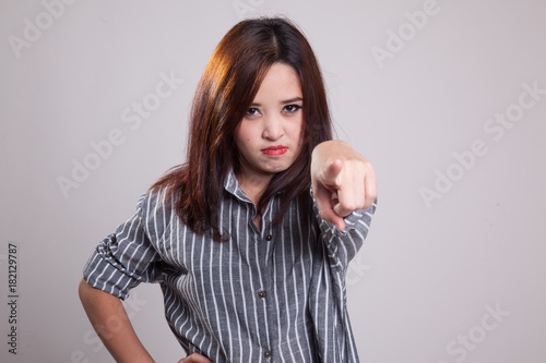Young Asian woman angry and point to camera.