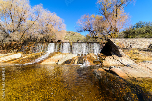 Water flows down a dam photo