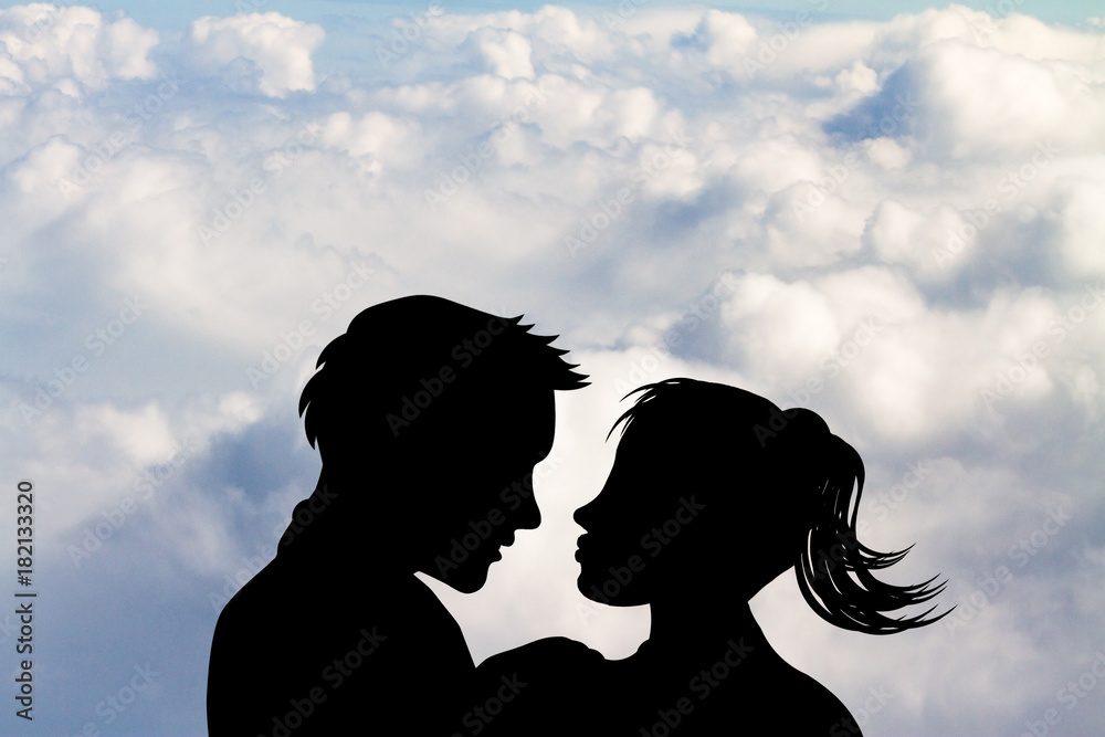 man and woman on kissing above the clouds