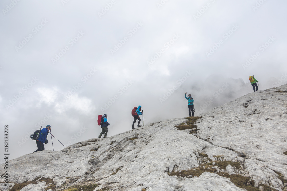 Tourists reaches the top of a rocky mountain