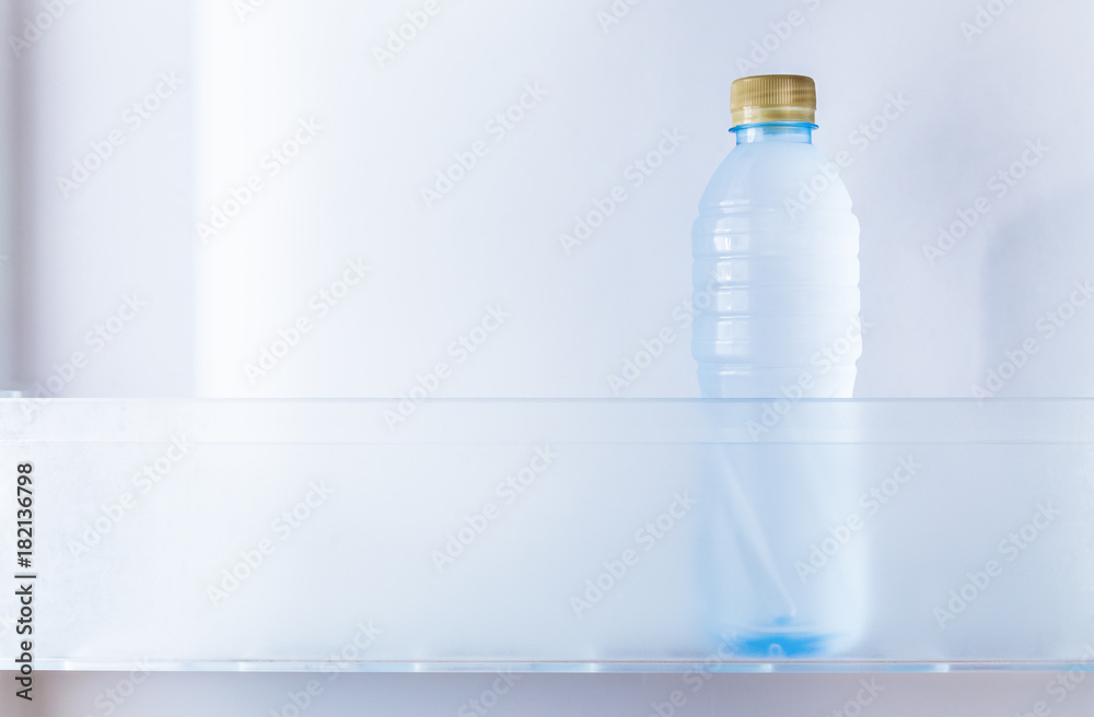 a cold bottle of drinking water in refrigerator a cold bottle of drinking water in refrigerator